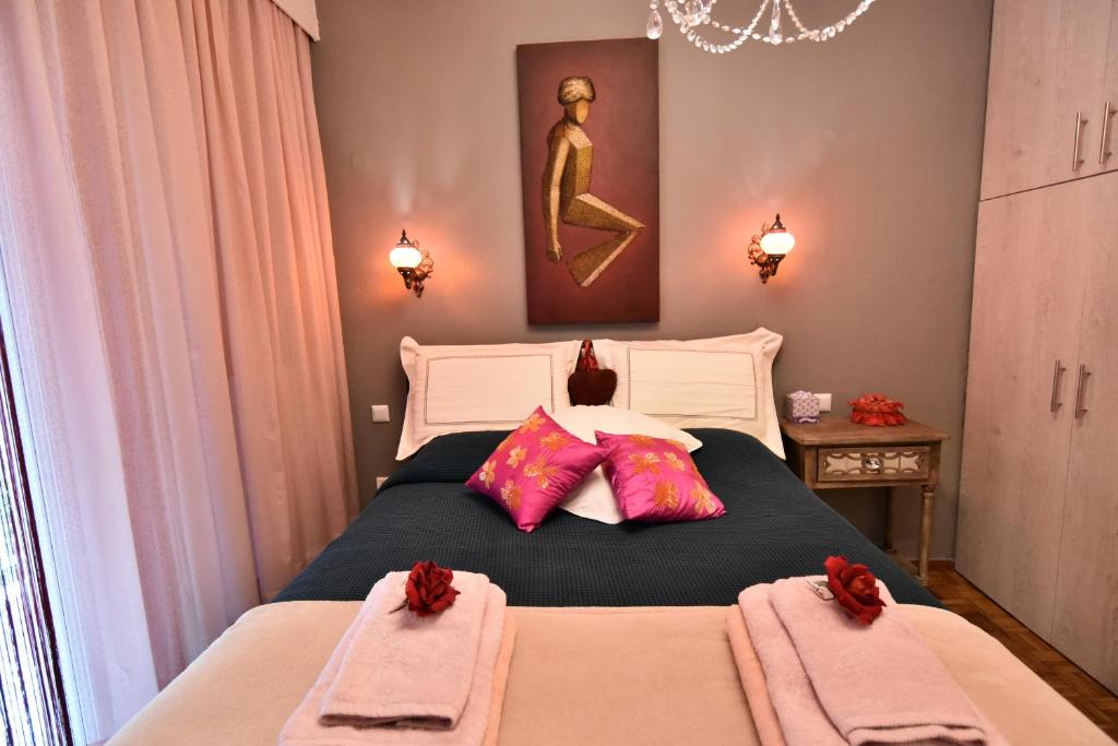 a bedroom with a bed with two towels on it at Queens Bed&Rest Luxury Apartment in Kavála