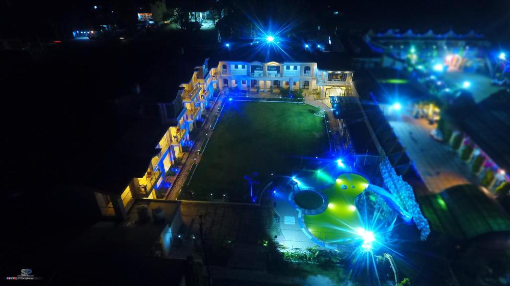 widok z powietrza na budynek z oświetleniem w nocy w obiekcie La Bellevue (Club & Resort) w mieście Ramnagar