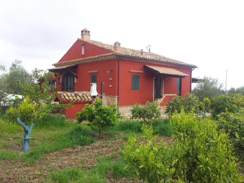 a red house in the middle of a field at Tenuta Sonia in Corigliano Calabro