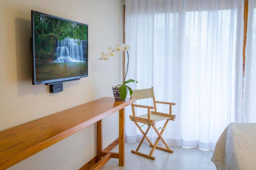 TV a/nebo společenská místnost v ubytování Pousada Catarina