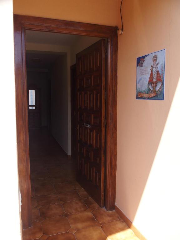 a hallway with a door and a picture on the wall at Casa Grande de Borizu Playa in Celorio