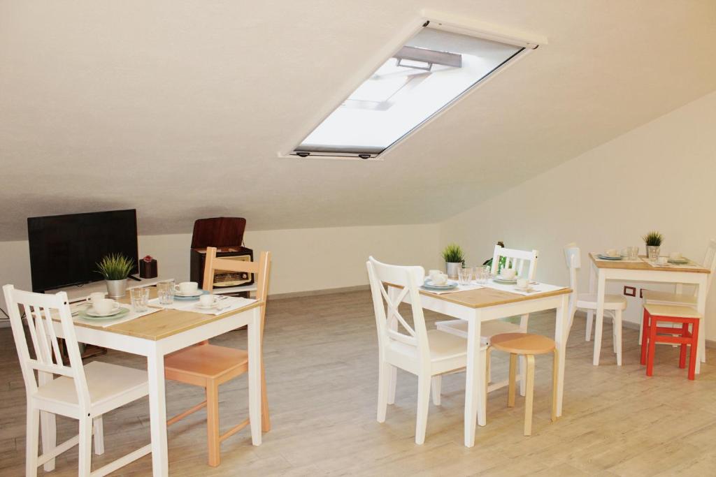 a dining room with tables and chairs and a skylight at Cielo Stellato in Castel Lagopesole