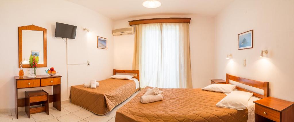 Postel nebo postele na pokoji v ubytování Pelagos Studios