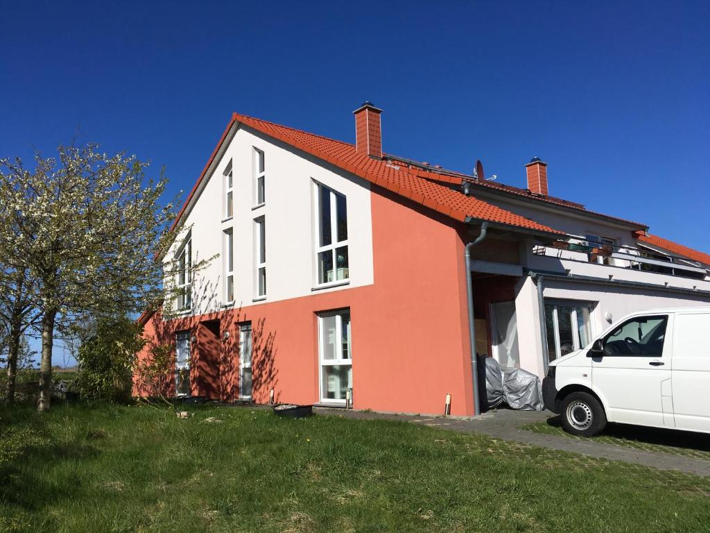 a white van parked in front of a house at Piratennest Ferienwohnung in Dranske