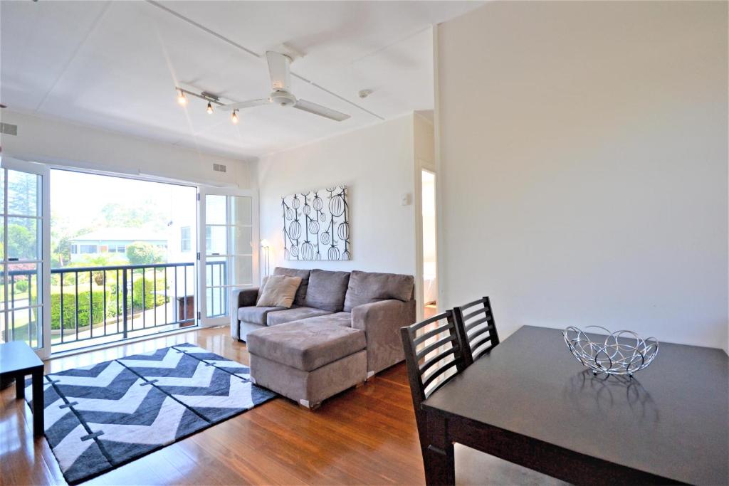 a living room with a couch and a table at Breakers 5 2 Hill Street in Port Macquarie
