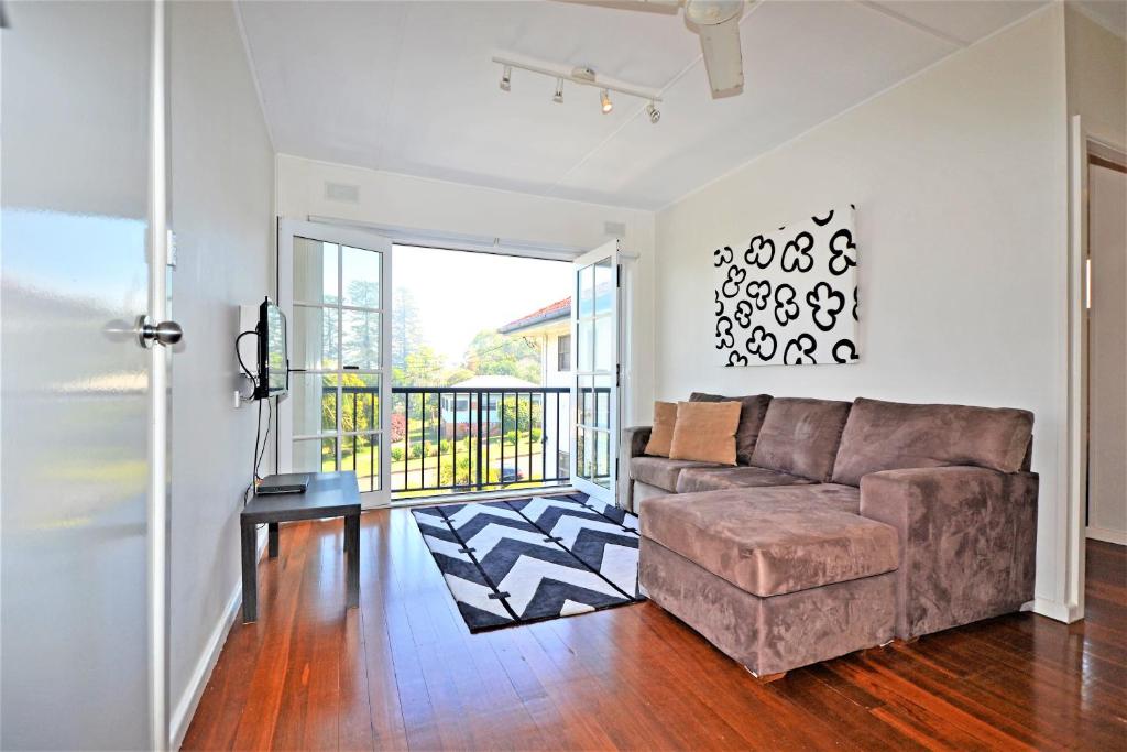 a living room with a couch and a balcony at Breakers 6 2 Hill Street in Port Macquarie