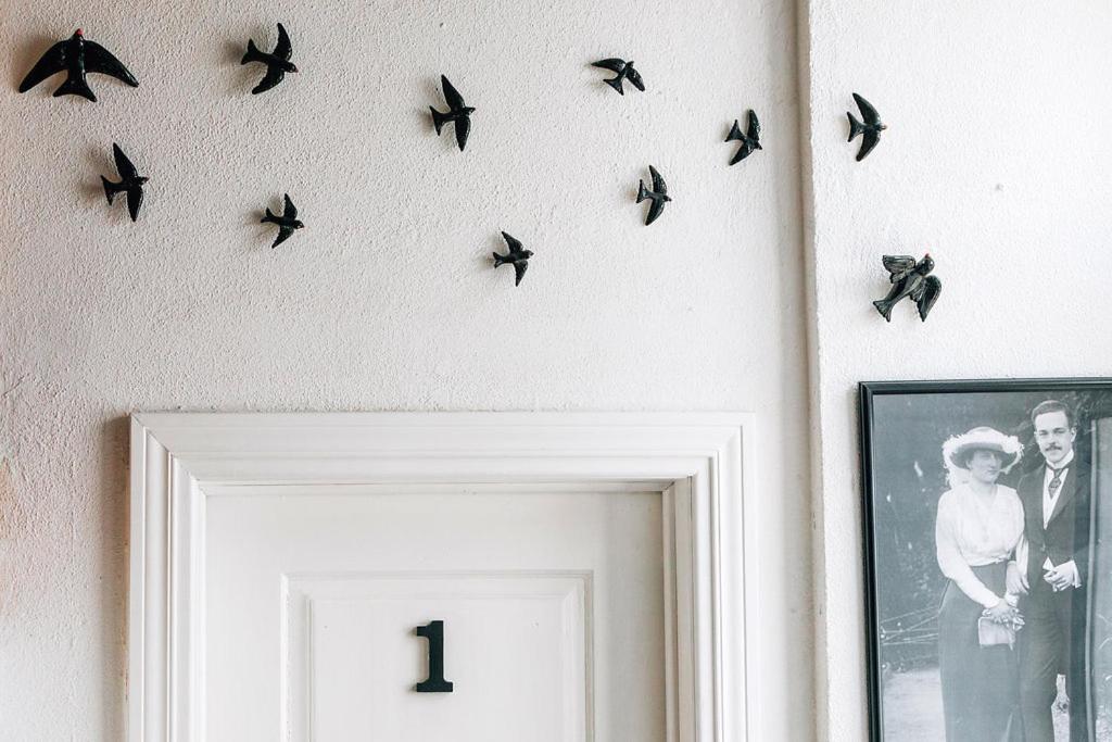 a group of birds hanging on a wall at Sintra1012 Boutique Guesthouse in Sintra