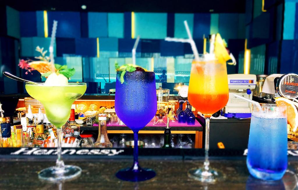 a group of three cocktails sitting on a bar at H2O HOTEL in Kaohsiung