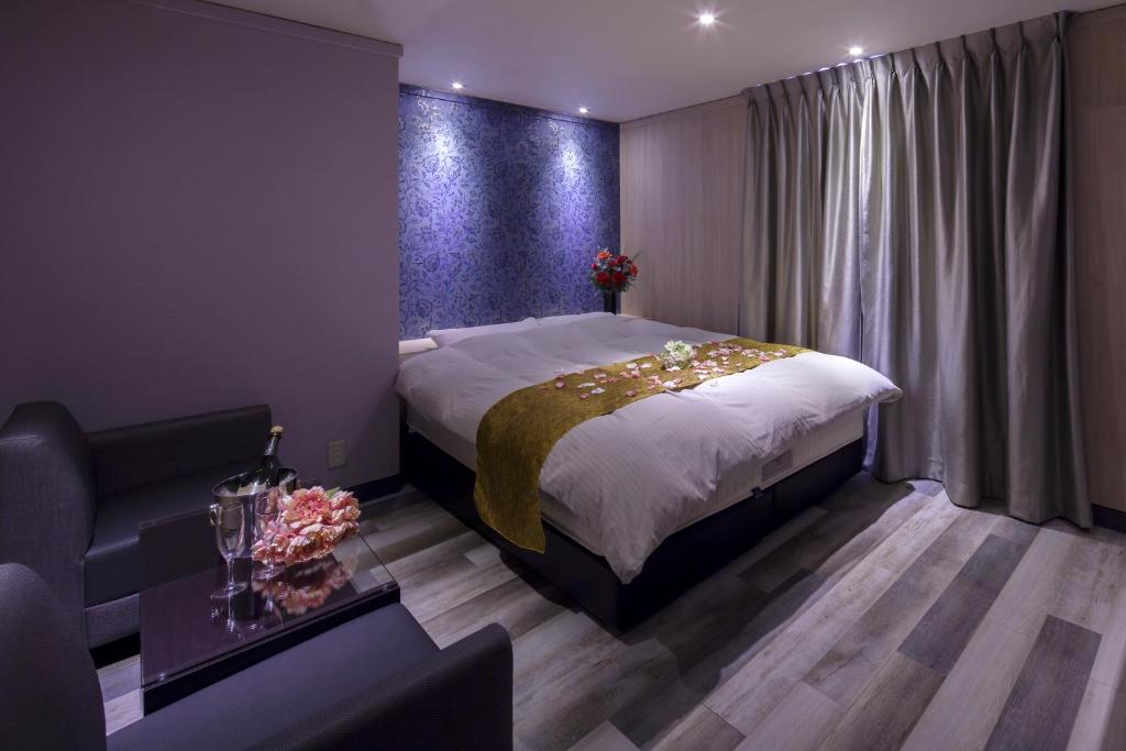 Postel nebo postele na pokoji v ubytování ホテルオリジン Hotel Origin 男塾ホテルグループ