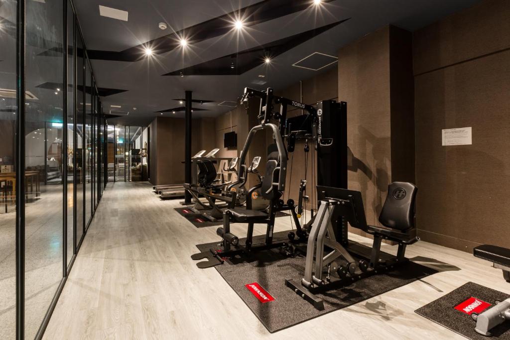 a gym with treadmills and elliptical machines at Green Hotel in Magong