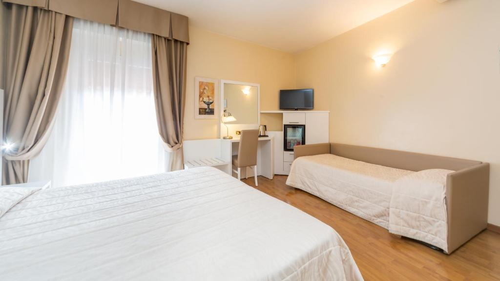 Postel nebo postele na pokoji v ubytování Hotel University