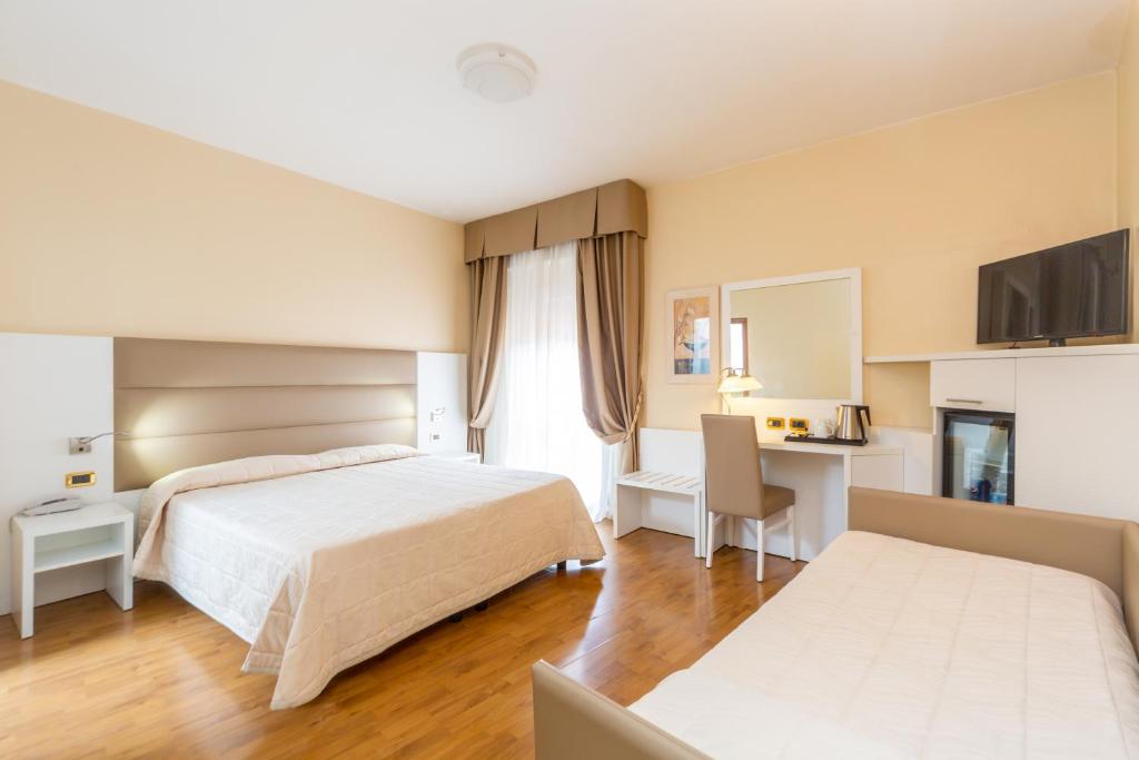 a hotel room with a bed and a desk at Hotel University in Bologna