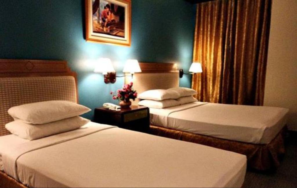 Postel nebo postele na pokoji v ubytování The Royal Mandaya Hotel