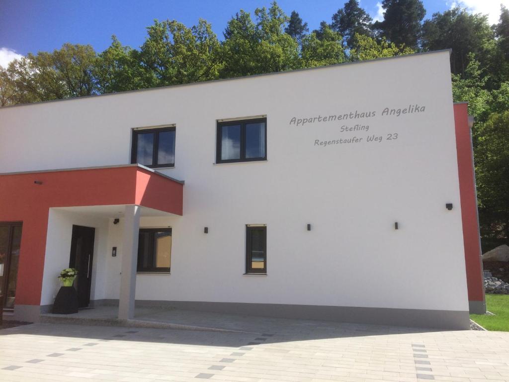 a white building with a sign on the side at Appartementhaus Angelika in Nittenau
