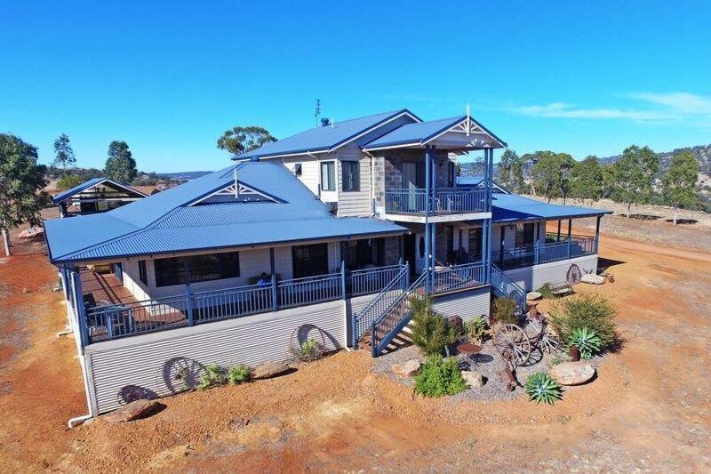 a large house in the middle of a field at Mountain Park Retreat in Perth