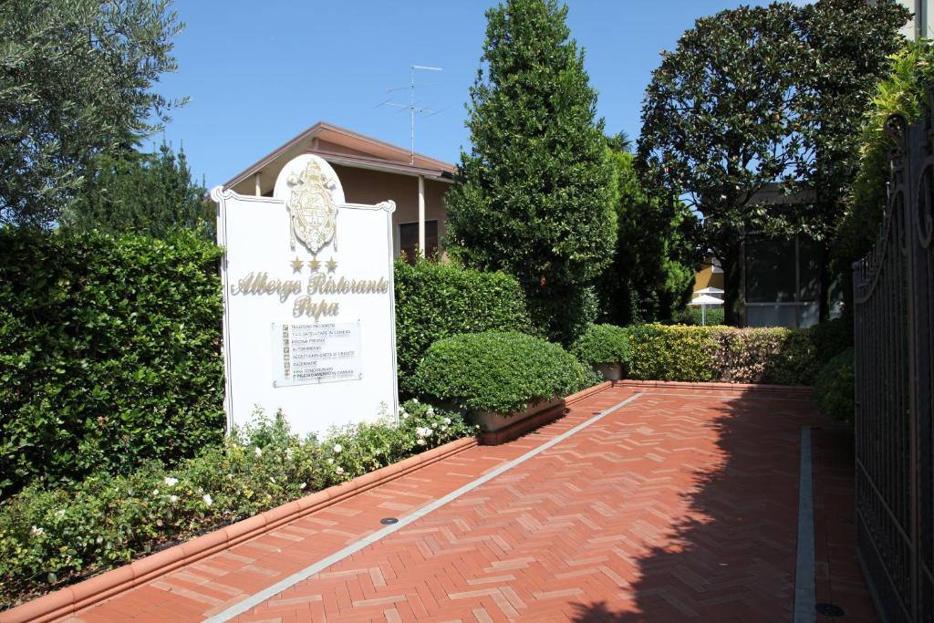 a monument in front of a building with a sign at Albergo Ristorante Papa in Peschiera del Garda