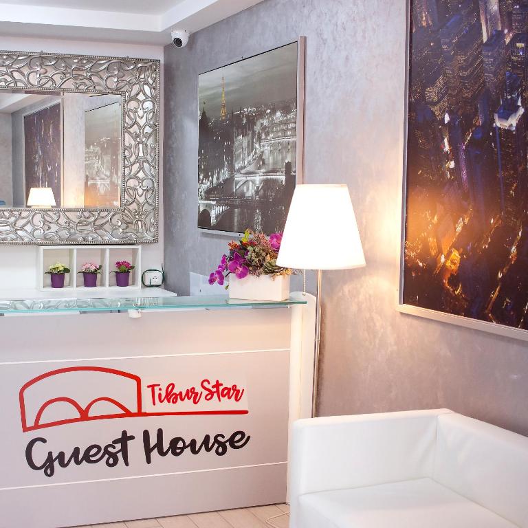 A bed or beds in a room at TIBUR STAR Guest House
