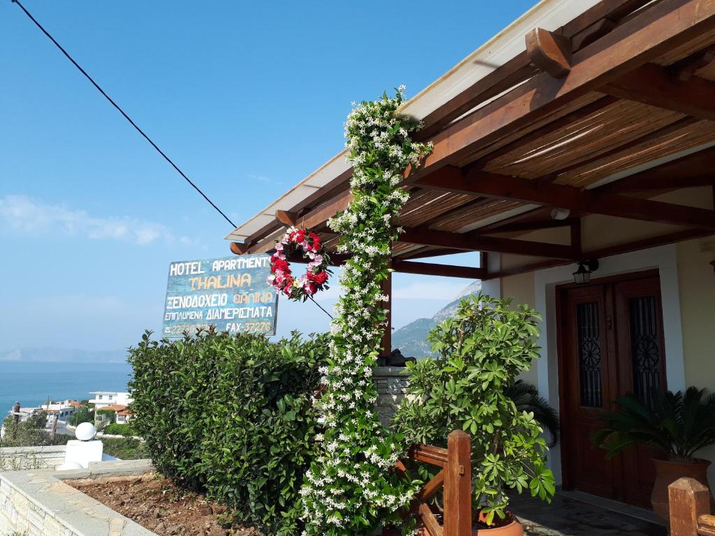 a building with flowers on the side of it at Thalina Hotel in Marathokampos