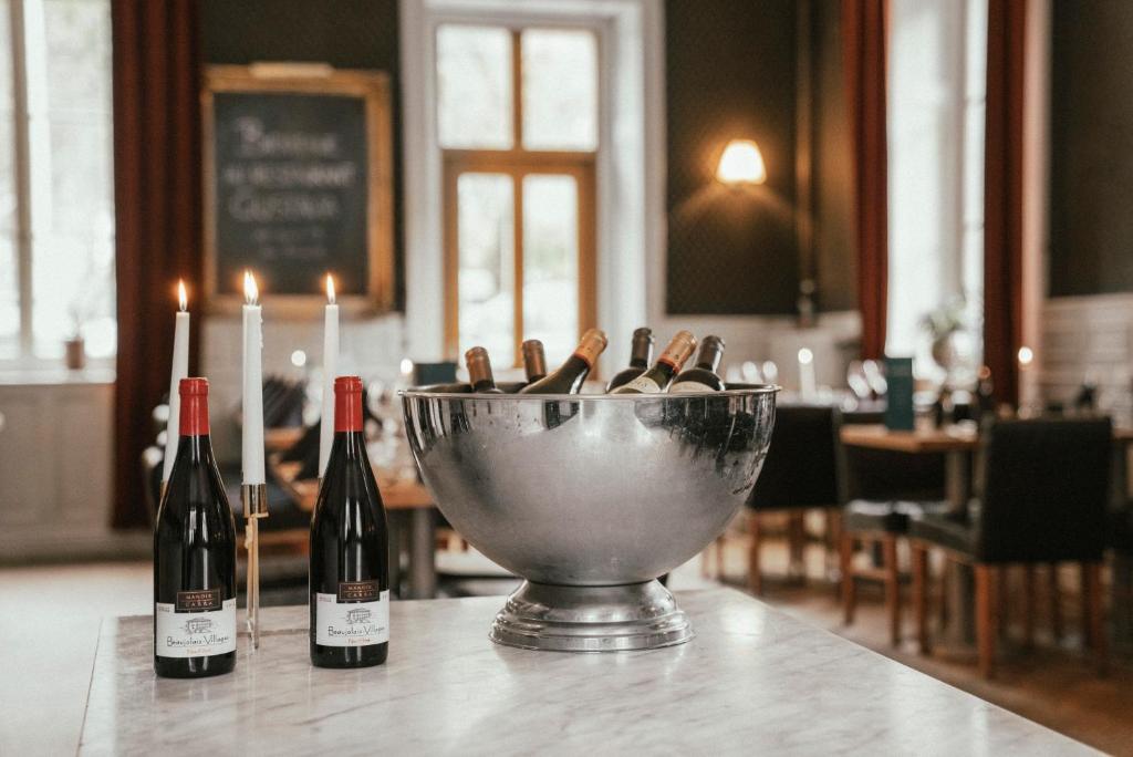 three bottles of wine in a bowl on a table at Langley Hotel Gustavia in Chamonix