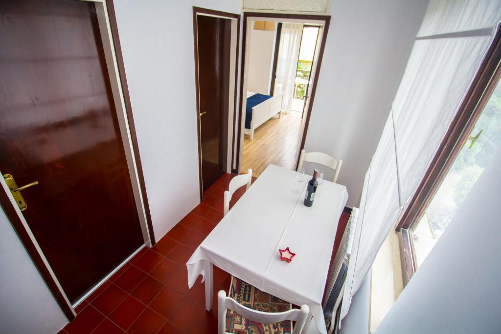 a small white table and chairs in a room at Pineta House Vidos in Poreč