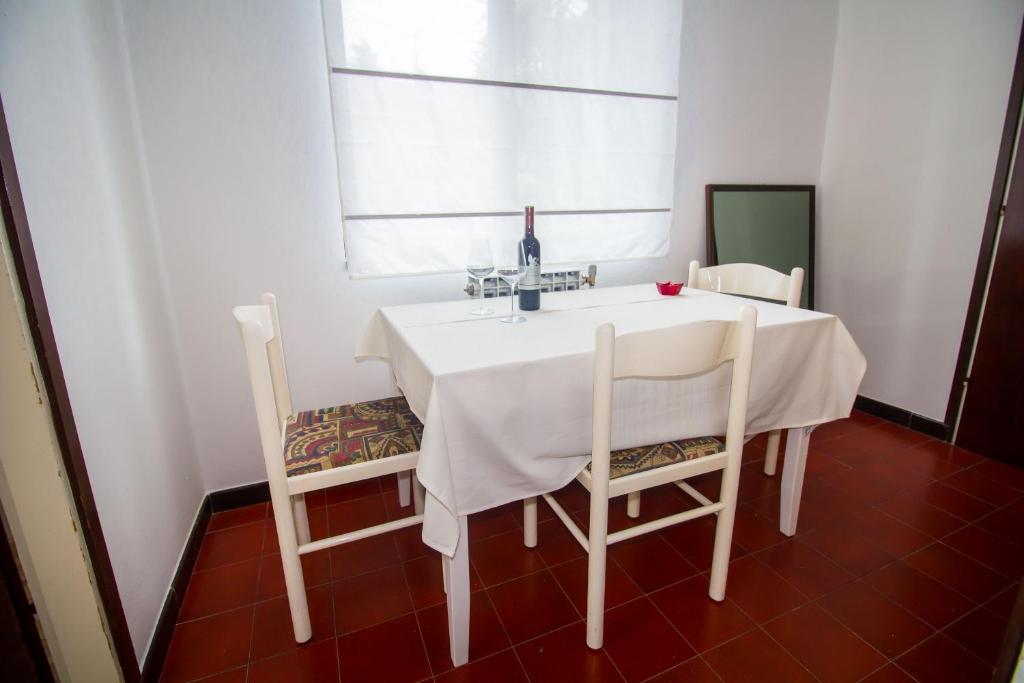 a white table with two chairs and a sink at Pineta House Vidos in Poreč