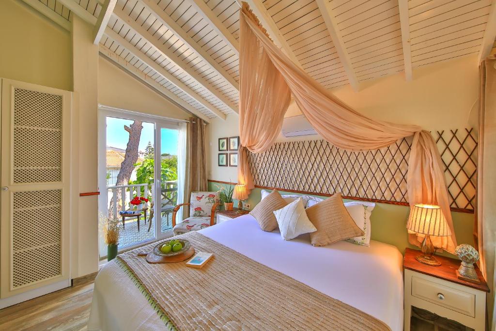 a bedroom with a bed with a canopy at Palas Ilıca in Çeşme