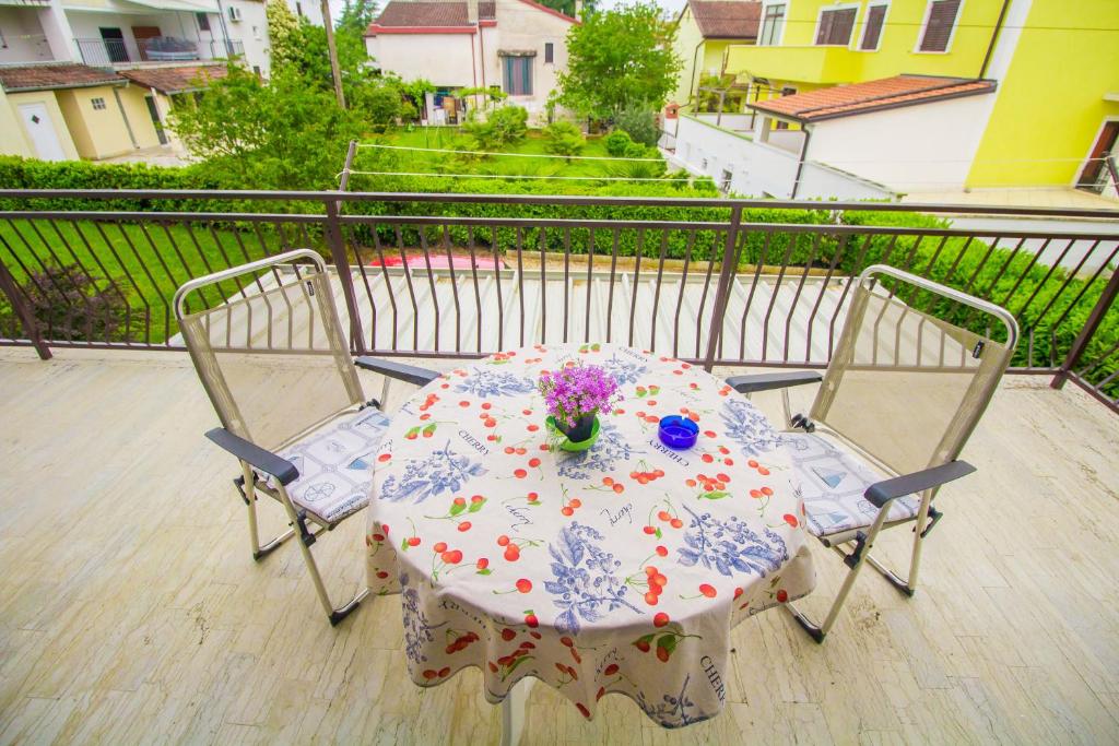 a table and two chairs on a balcony at Pineta House Vidos in Poreč