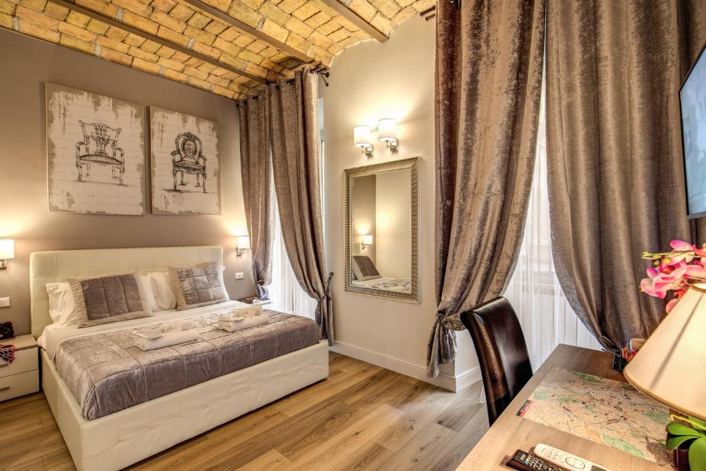 a bedroom with a large bed and a large window at Chester Suites in Rome