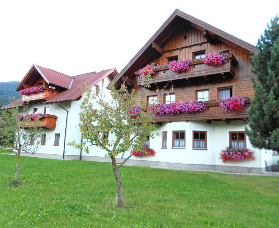 a house with flowers on the balconies on it at Pension Thorerhof in Haus im Ennstal