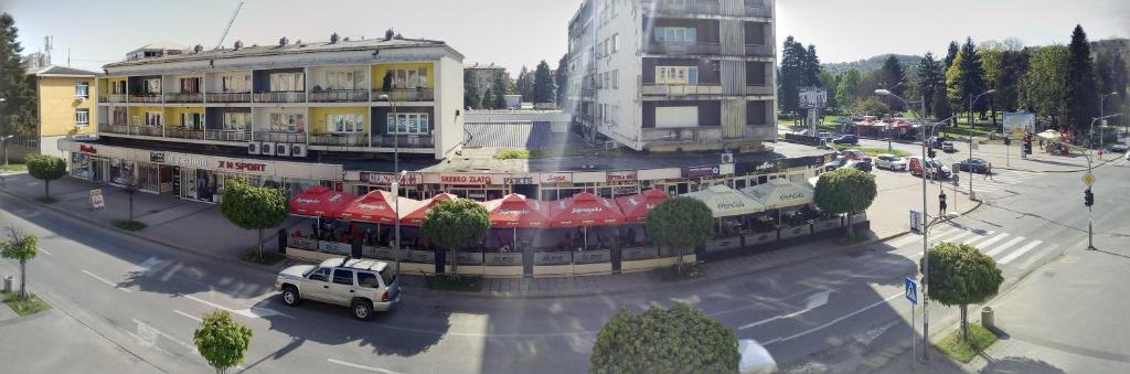 a white truck parked in front of a building at Lara in Doboj