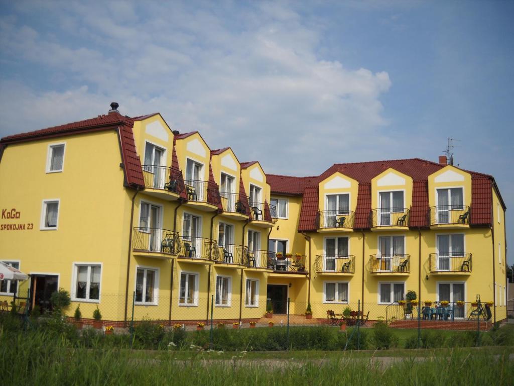 a row of yellow buildings with balconies on them at Pensjonat KoGa in Kołobrzeg