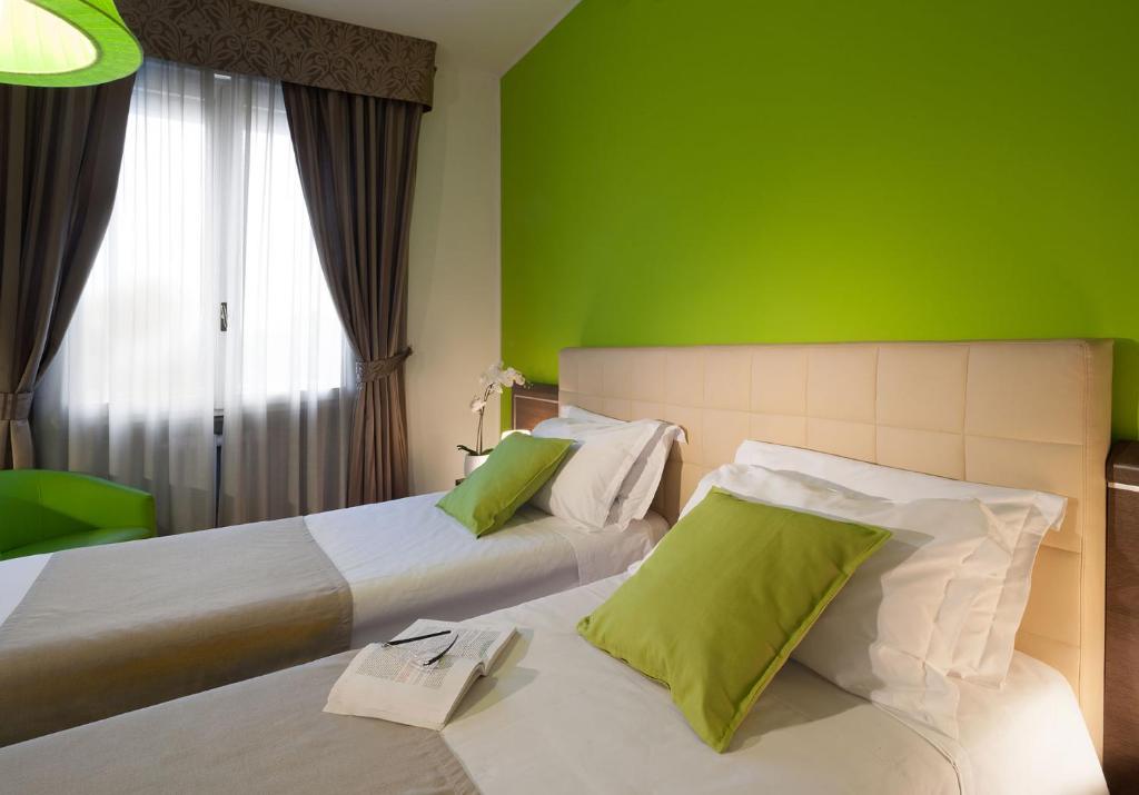 Postel nebo postele na pokoji v ubytování Hotel Milano Palmanova