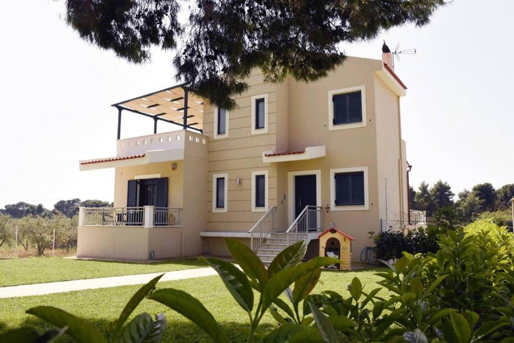 a view of the house from the garden at Panelma Villa Tranquil Coastal Retreat in Zacharo in Tholón