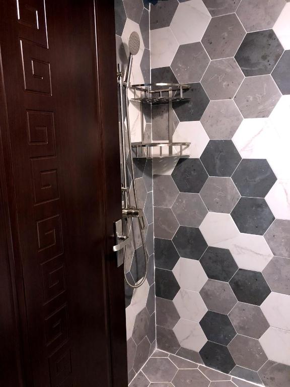 a bathroom with a shower with a glass door at Saipan Skyline Designers Hotel in Saipan