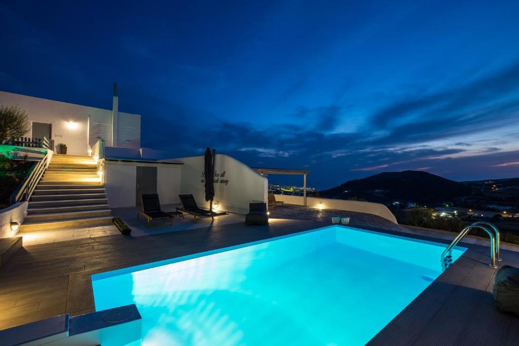 a villa with a swimming pool at night at Paros Villas Nereids in Parikia