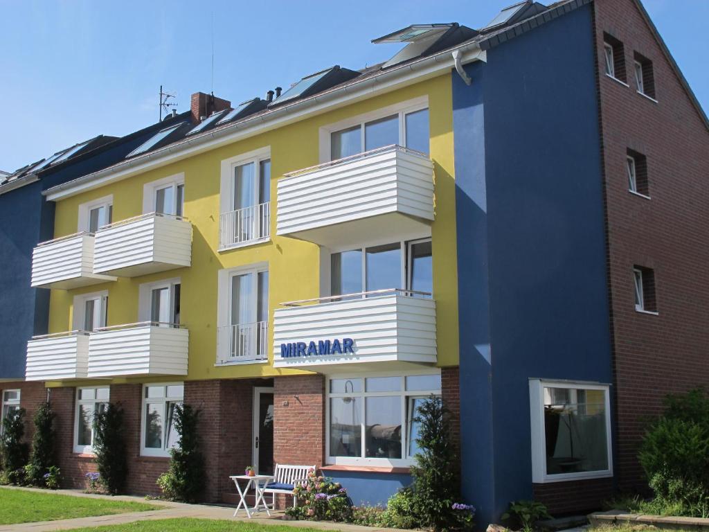 an apartment building with a yellow and blue facade at Miramar in Helgoland