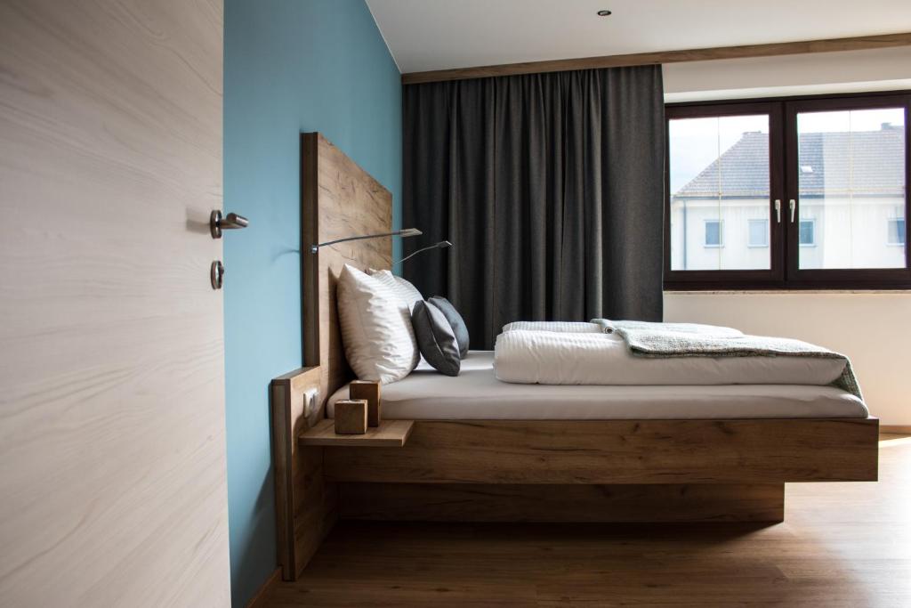 una camera con letto in legno e finestra di Flussbett a Kirchberg an der Pielach