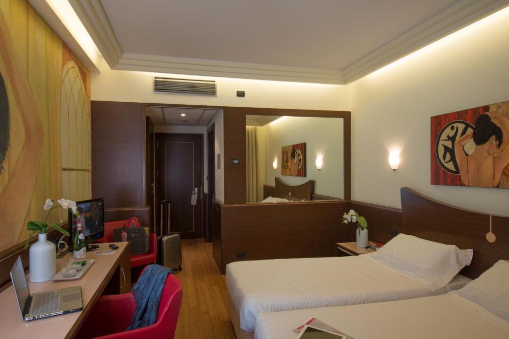 A bed or beds in a room at As Hotel Cambiago