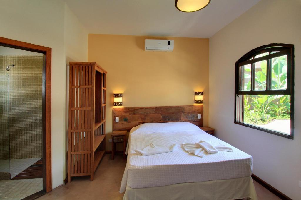 Cama ou camas em um quarto em Pousada Tupinamba
