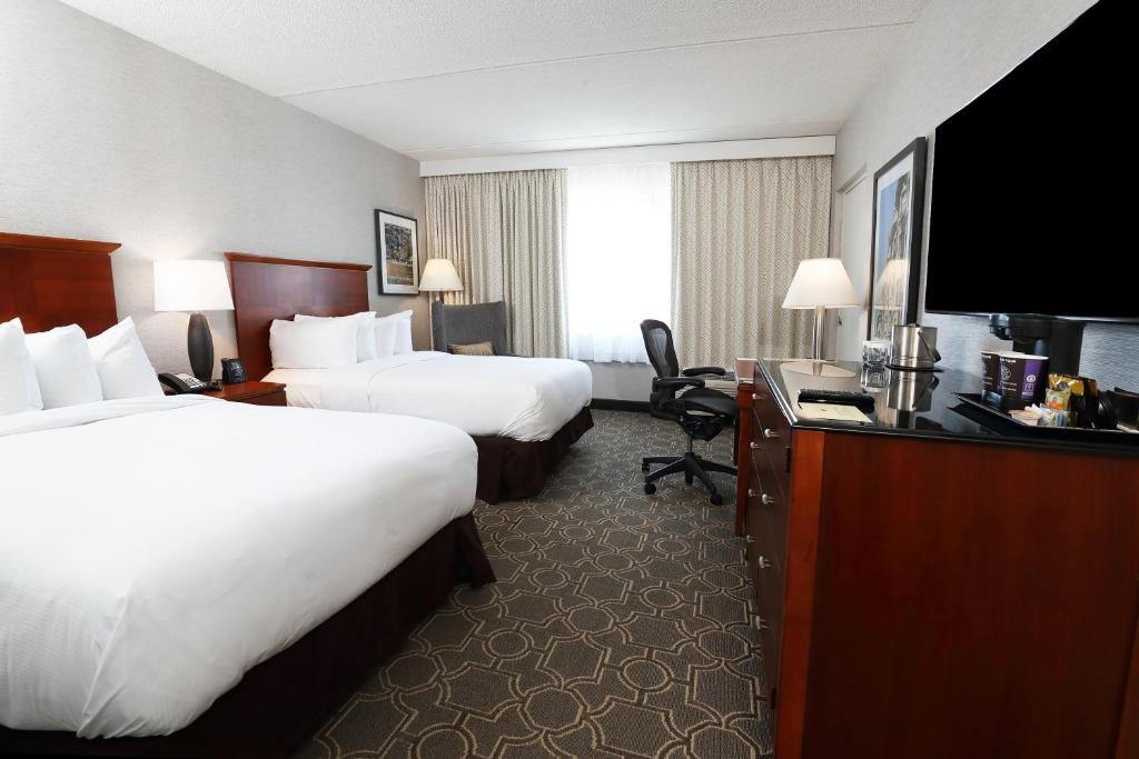 a hotel room with two beds and a desk at DoubleTree by Hilton Boston/Westborough in Westborough