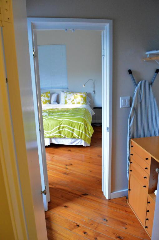 a bedroom with a bed and a wooden floor at Modern B & B in Houston