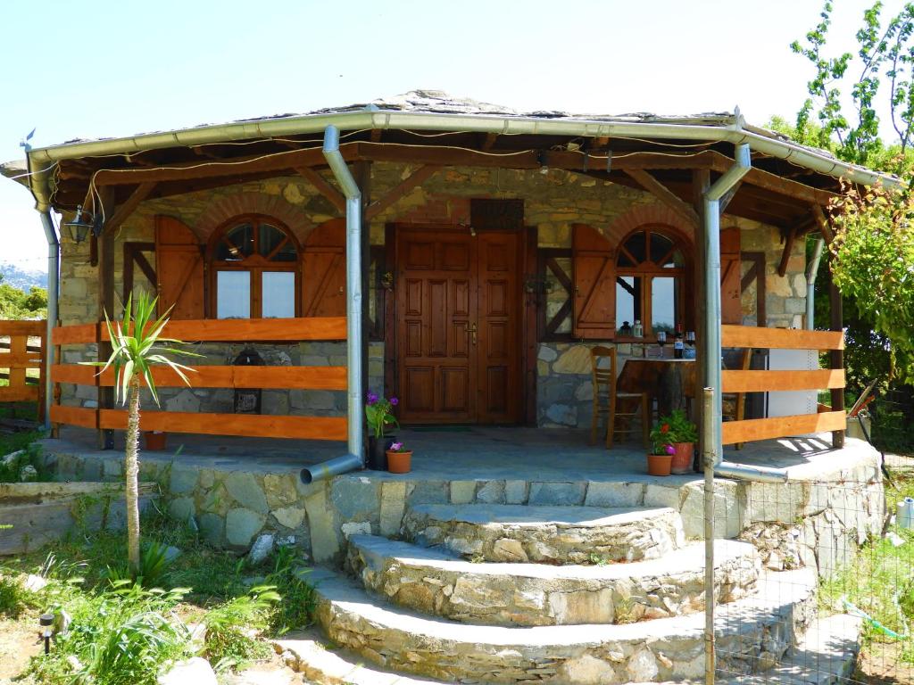 a small stone house with a porch and stairs at Mountain House Kastro in Kástron