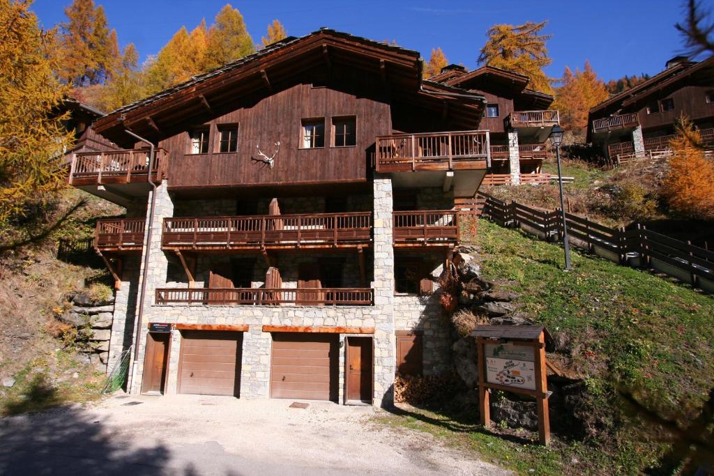 a large wooden house with two garage doors at Chalet Chardons Belvedere in Tignes