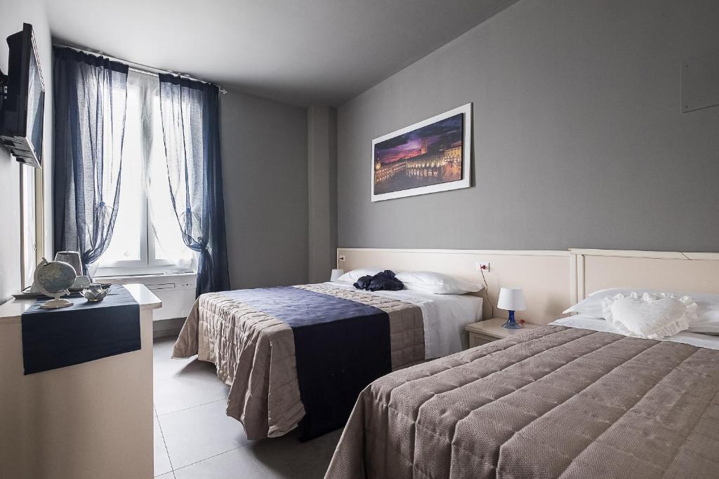 Ένα ή περισσότερα κρεβάτια σε δωμάτιο στο Affittacamere Ambra