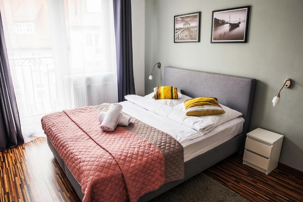 a bedroom with a bed with a towel on it at Apartamenty Centrum in Koszalin