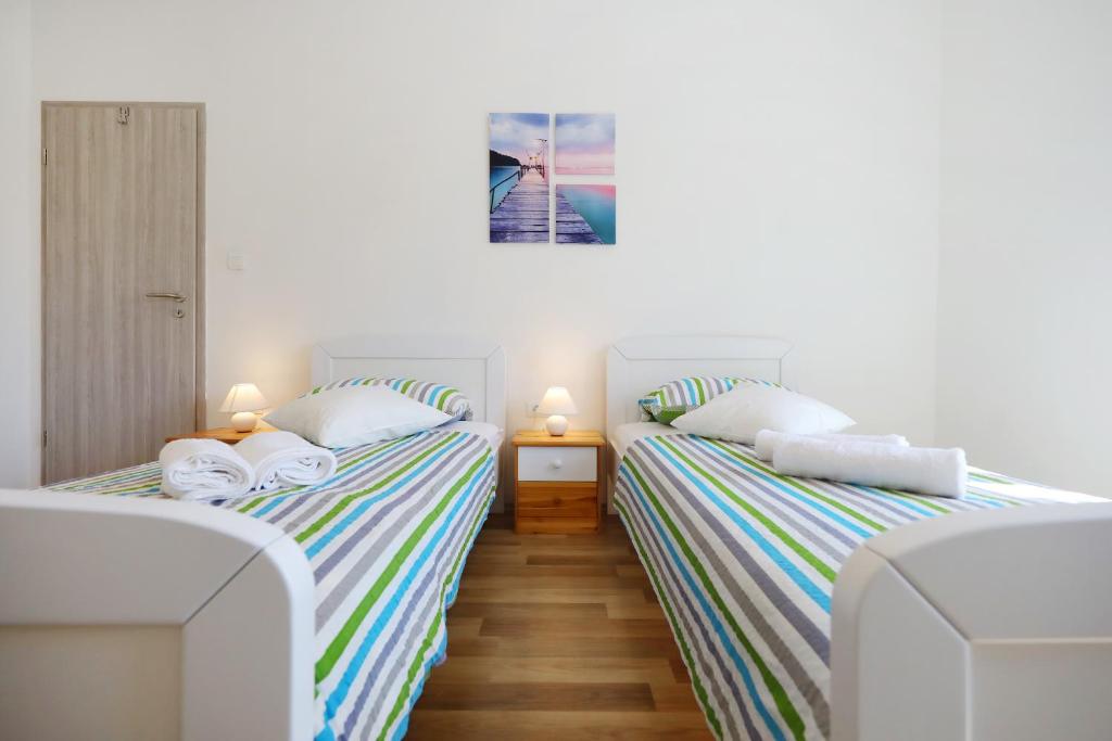Postel nebo postele na pokoji v ubytování Apartman Dendo