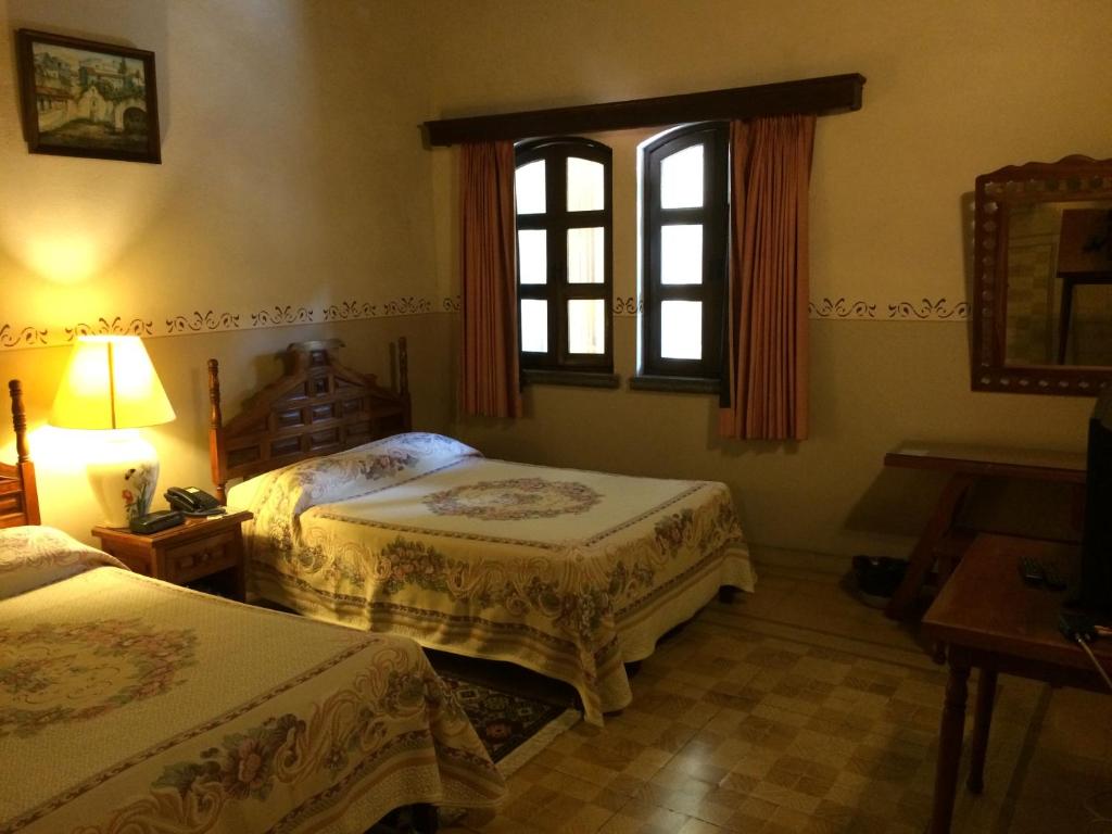 Postel nebo postele na pokoji v ubytování Posada Coatepec