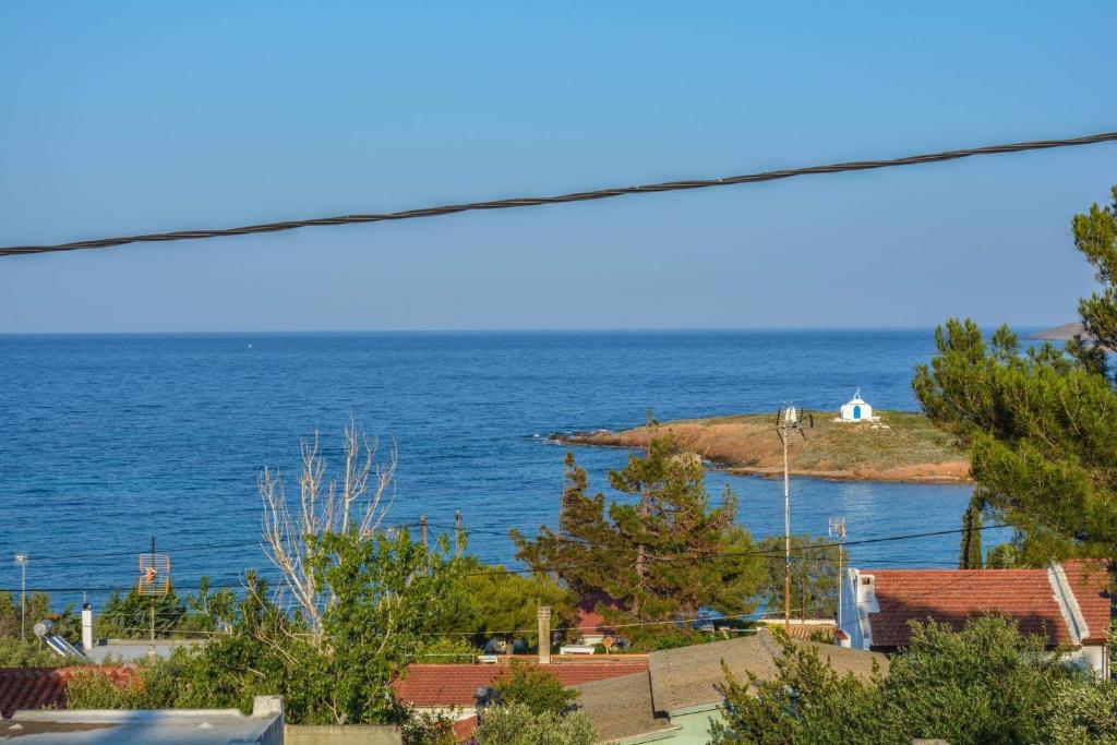 a view of the ocean from a house at Sofia's sea view house in Vravrona