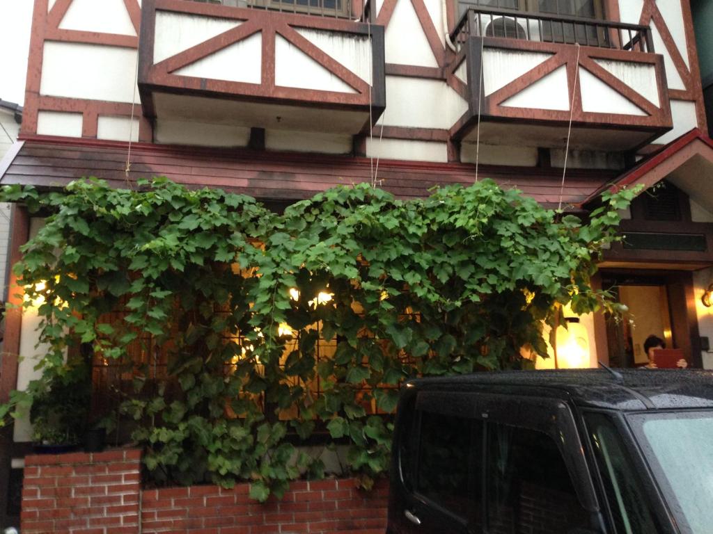 a building with a plant on the side of it at Pension Baden Heim in Nagasaki