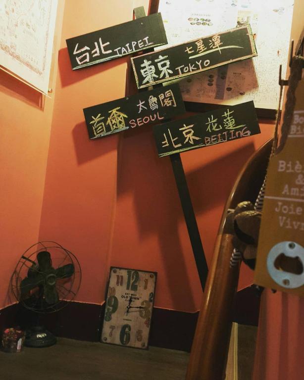 a group of signs on a shelf in a room at 角舍背包客棧 -近火車站 in Hualien City